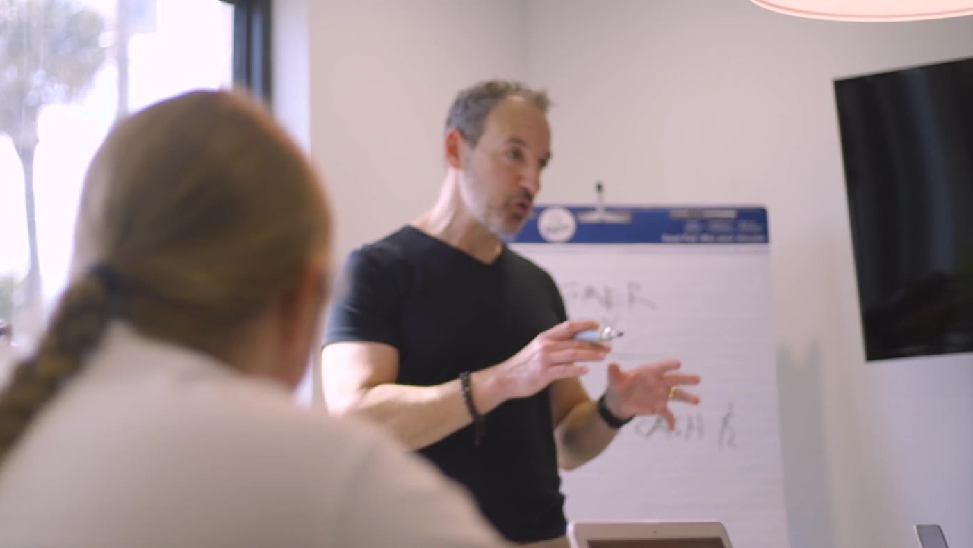 Jay coaching a client at the whiteboard